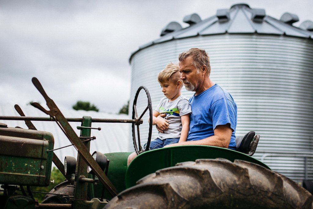 Grandpa and grandson on a tractor